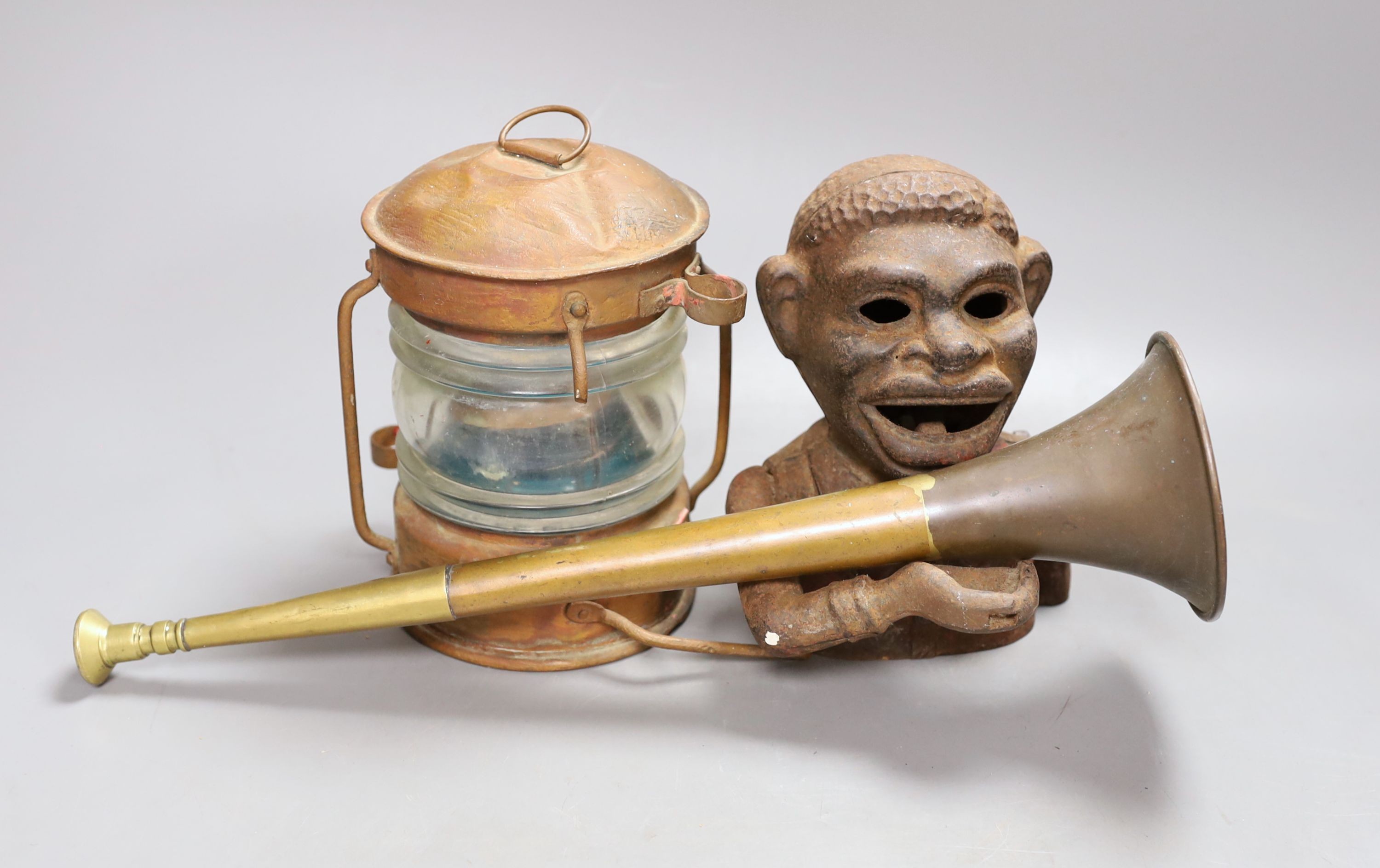 A cast money bank, copper horn and a ship's lamp, 20 cms high.